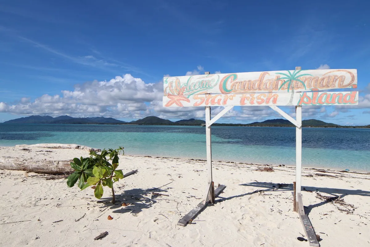 White sand and shallow turquoise water at Candaraman Island in Balabac, Palawan.