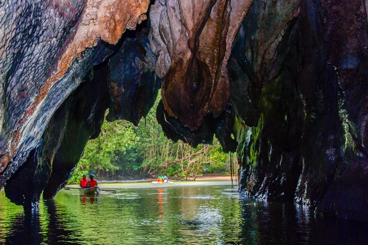 The cave entrance of the Puerto Princesa Subterranean River, framed by jungle-covered limestone.